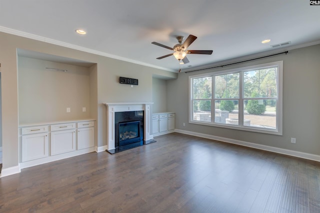 unfurnished living room featuring ornamental molding, dark wood-style flooring, a high end fireplace, and baseboards