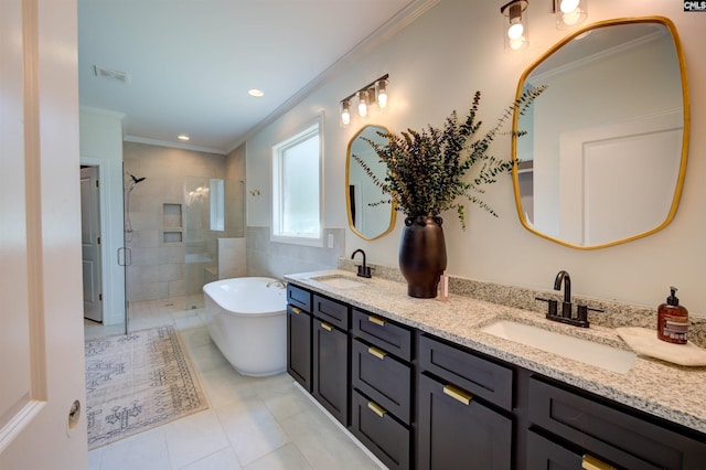 bathroom with crown molding, a stall shower, a freestanding tub, and a sink