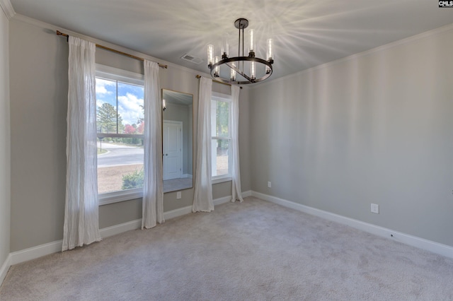 spare room with ornamental molding, carpet, visible vents, and a notable chandelier