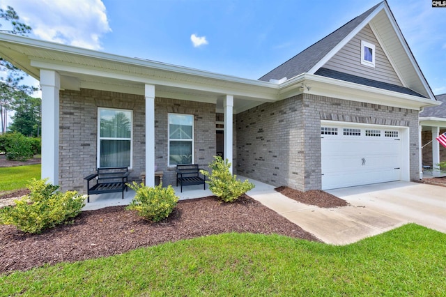 single story home featuring driveway, covered porch, an attached garage, and brick siding