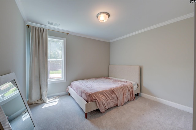 bedroom with ornamental molding, light colored carpet, visible vents, and baseboards