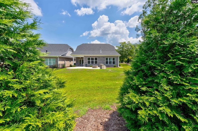 back of house featuring a patio area, fence, and a lawn