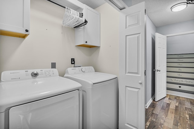 laundry area with a textured ceiling, dark wood finished floors, cabinet space, and washer and dryer