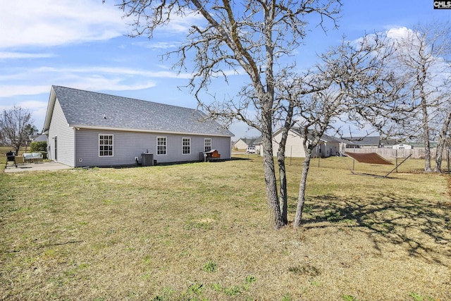 view of yard featuring central AC unit, fence, and a patio