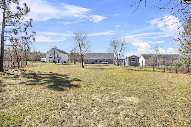 view of yard featuring fence and a carport