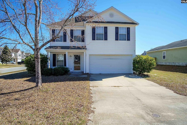 traditional home featuring driveway and an attached garage