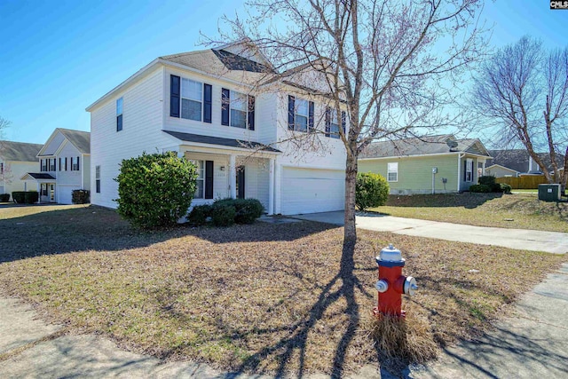 view of front of home featuring a garage, concrete driveway, and a front yard