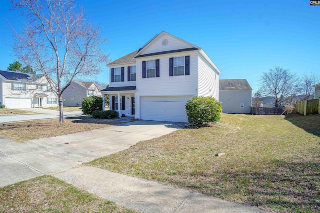 traditional-style house with a garage, driveway, a front yard, and fence