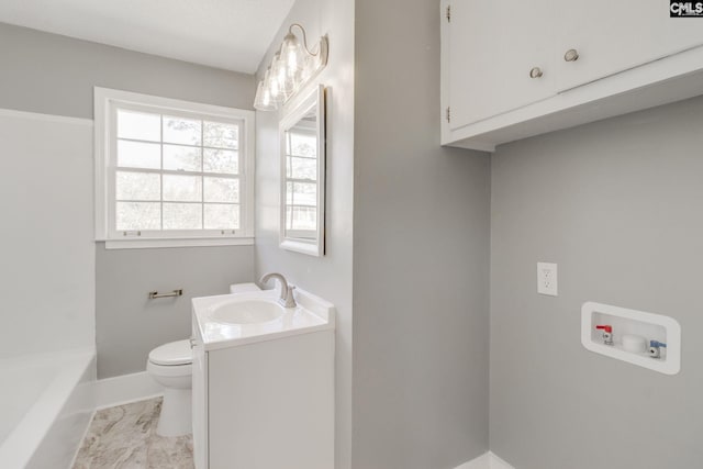 bathroom with a washtub, marble finish floor, toilet, vanity, and baseboards