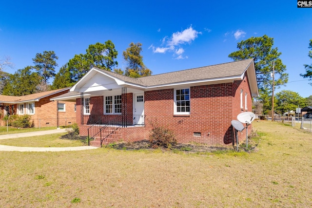 view of front of house featuring brick siding, a shingled roof, fence, crawl space, and a front yard