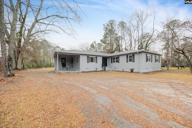 view of front of house featuring driveway and crawl space