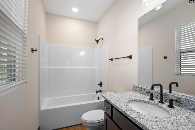 bathroom featuring shower / tub combination, vanity, and toilet