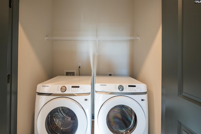 clothes washing area featuring laundry area and separate washer and dryer