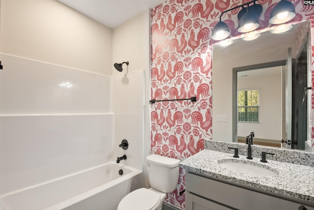 bathroom with tub / shower combination, vanity, and toilet