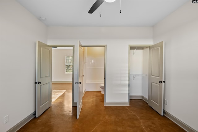 unfurnished bedroom featuring a closet, ceiling fan, finished concrete flooring, and baseboards