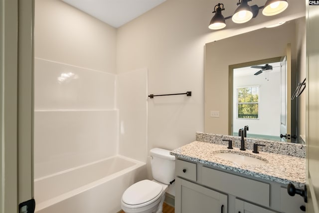 bathroom with toilet, tub / shower combination, a ceiling fan, and vanity