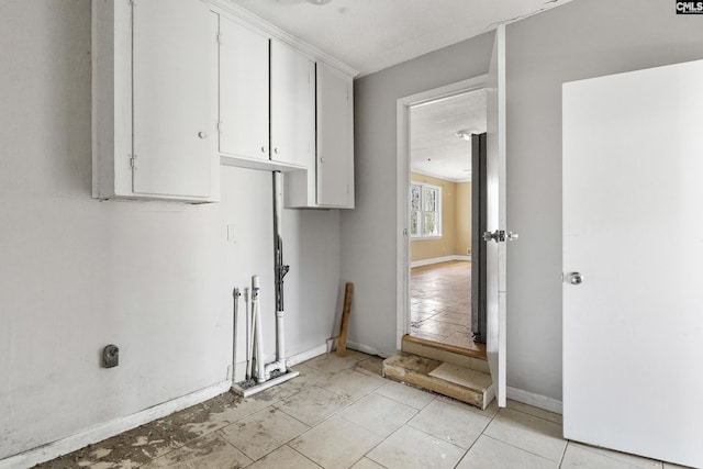 laundry area with baseboards