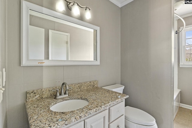 bathroom featuring ornamental molding, tile walls, toilet, and vanity