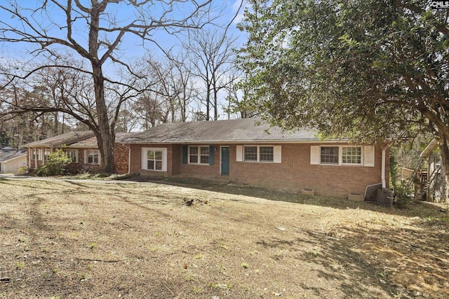 ranch-style house featuring brick siding