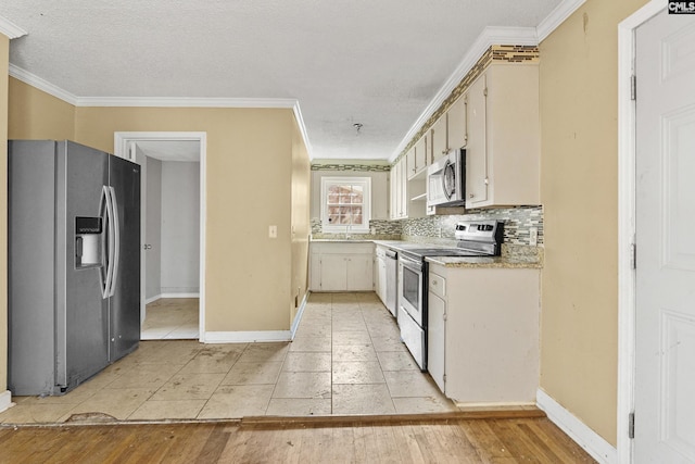 kitchen featuring crown molding, stainless steel appliances, light countertops, and decorative backsplash