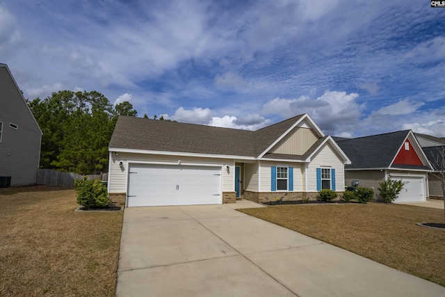 view of front of house with driveway, brick siding, an attached garage, fence, and a front yard