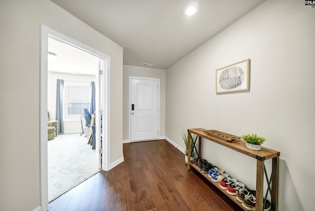 interior space with dark wood-type flooring, recessed lighting, visible vents, and baseboards