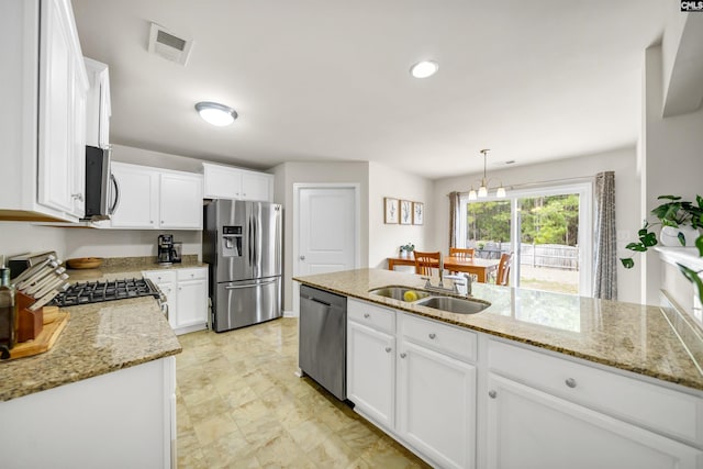 kitchen with white cabinetry, visible vents, appliances with stainless steel finishes, and a sink