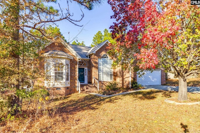 view of front of house featuring a front lawn, crawl space, brick siding, and concrete driveway