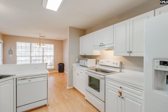 kitchen with light countertops, white appliances, white cabinetry, and under cabinet range hood