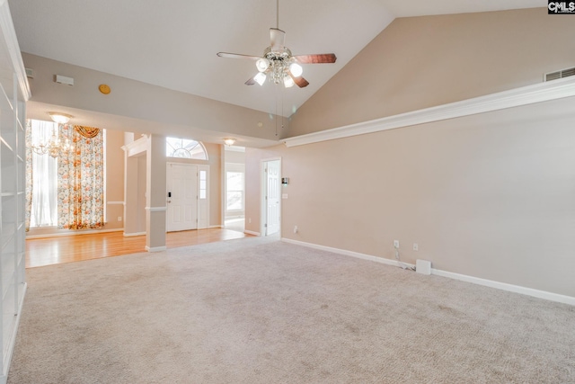 carpeted spare room with high vaulted ceiling, visible vents, ceiling fan, and baseboards