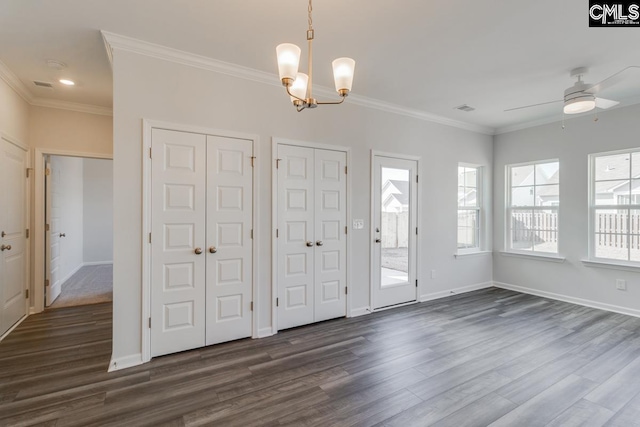 foyer entrance featuring dark wood finished floors, crown molding, and baseboards