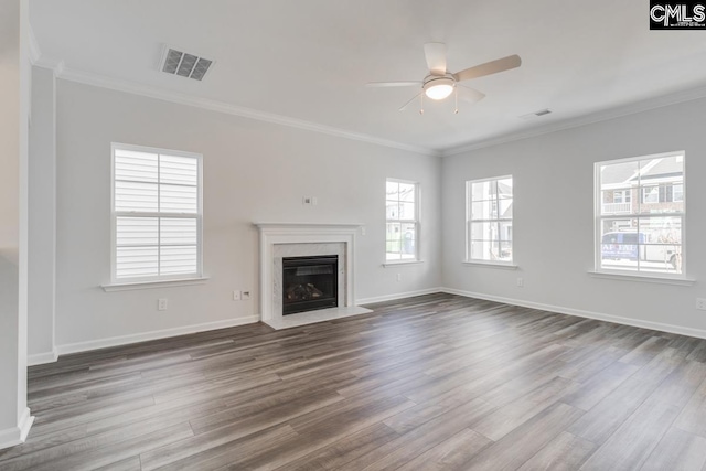 unfurnished living room featuring dark wood-type flooring, a high end fireplace, visible vents, and ornamental molding