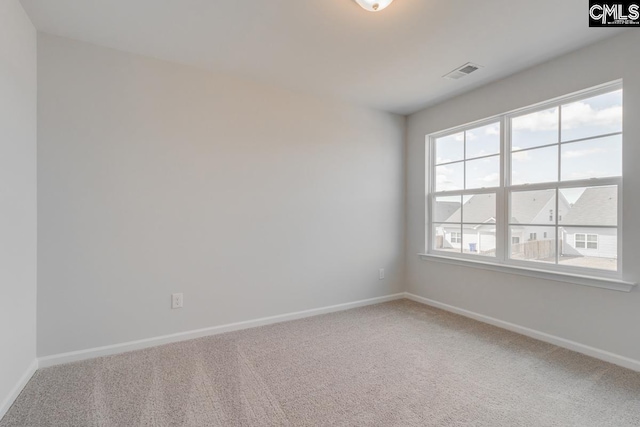 empty room featuring baseboards, visible vents, and carpet flooring