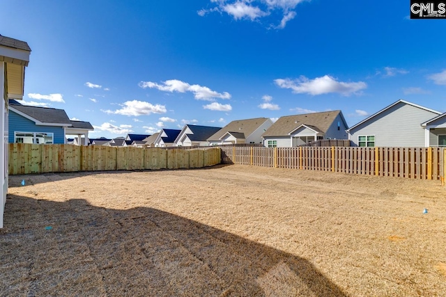 view of yard with a residential view and a fenced backyard