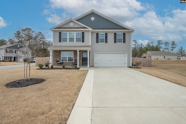 craftsman-style home featuring driveway, an attached garage, fence, and a front yard