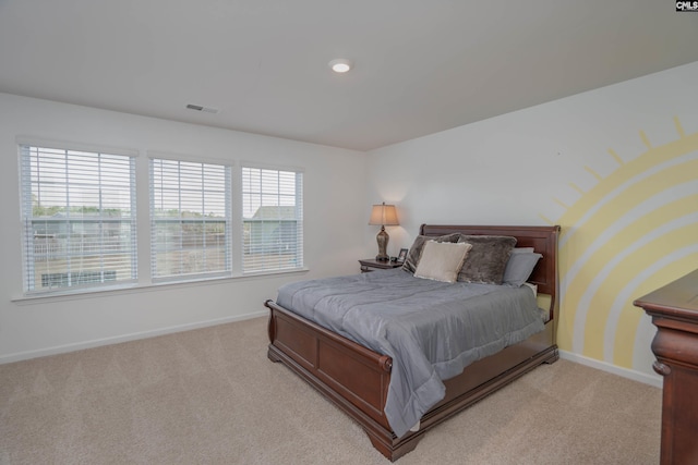 bedroom featuring visible vents, baseboards, and light colored carpet