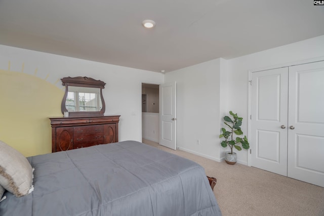 carpeted bedroom featuring a closet and baseboards