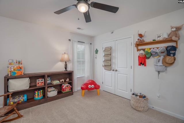 game room with a ceiling fan, carpet, visible vents, and baseboards