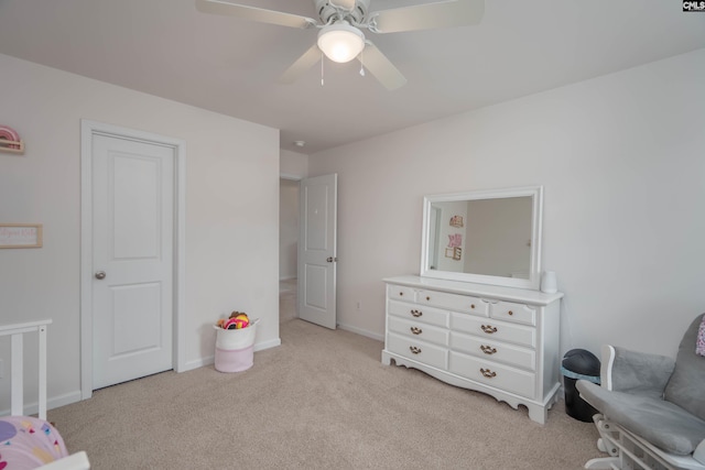 bedroom with light carpet, ceiling fan, and baseboards