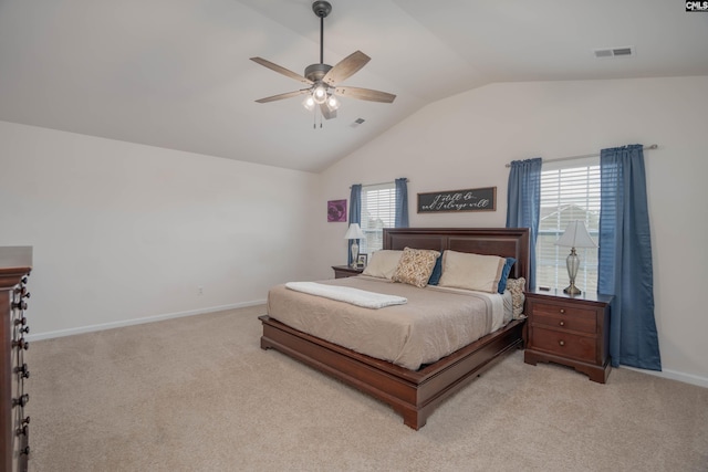 bedroom with vaulted ceiling, baseboards, visible vents, and light colored carpet