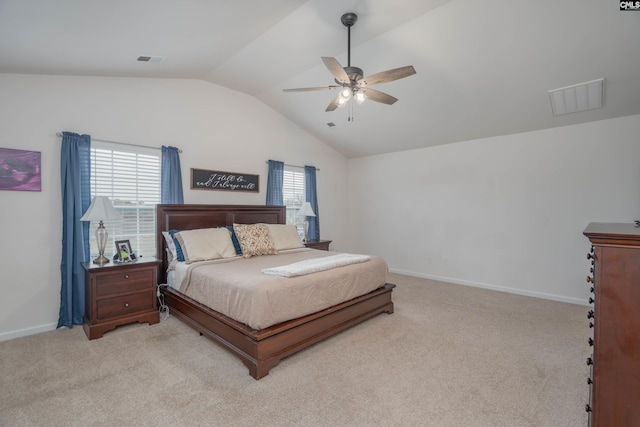 bedroom with vaulted ceiling, baseboards, visible vents, and light colored carpet