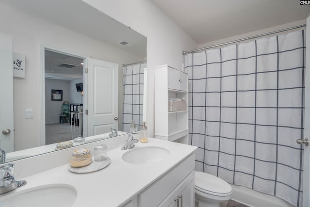 full bathroom with double vanity, visible vents, toilet, and a sink