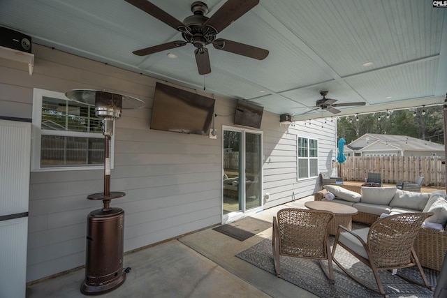 view of patio / terrace with fence, outdoor lounge area, and a ceiling fan