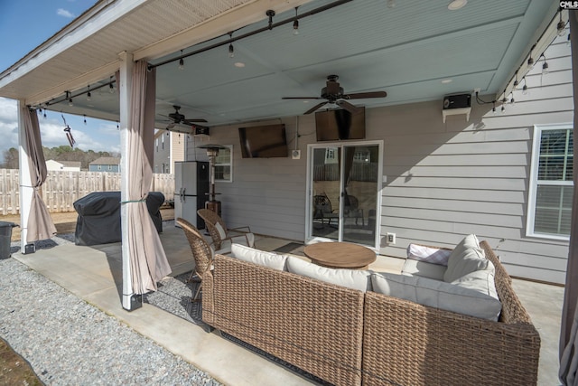 view of patio with a ceiling fan, fence, and an outdoor living space