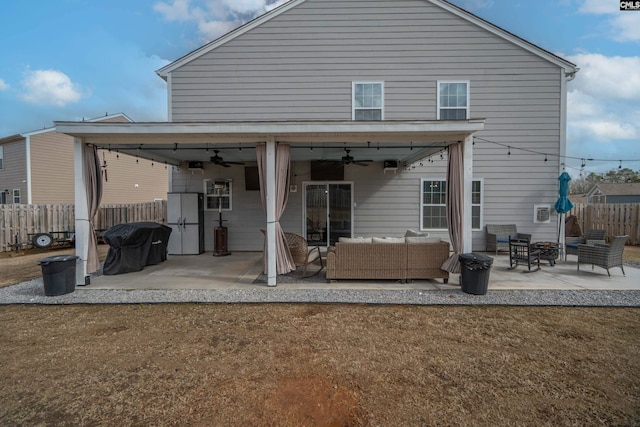 rear view of property with ceiling fan, fence, outdoor lounge area, and a patio