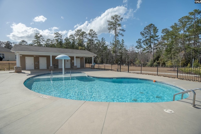 pool featuring fence and a patio