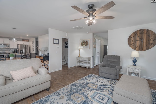 living area with visible vents, baseboards, ceiling fan, wood finished floors, and recessed lighting