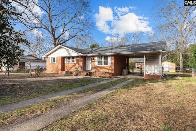 view of front facade with fence, driveway, crawl space, a carport, and a front lawn