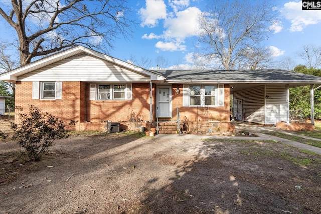 single story home featuring brick siding