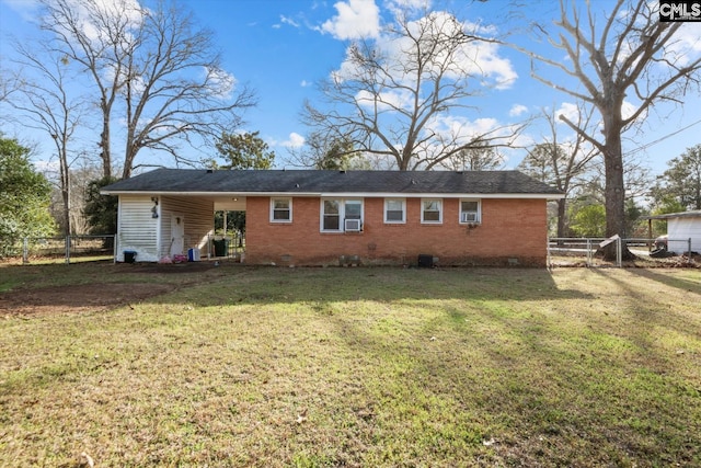 rear view of property with a yard, brick siding, crawl space, and fence